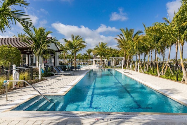 community pool featuring a patio area and fence