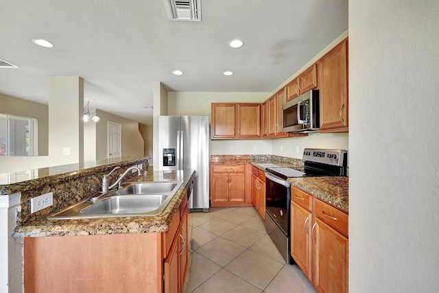 kitchen featuring sink, appliances with stainless steel finishes, a chandelier, and light tile patterned floors