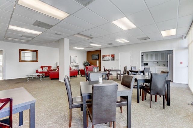 dining space featuring a drop ceiling