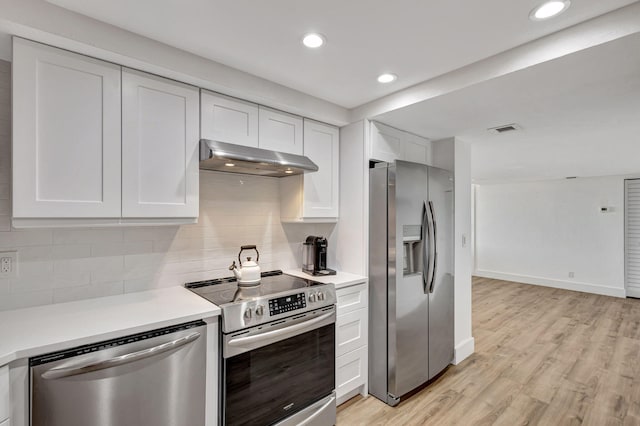 kitchen with white cabinetry, ventilation hood, and appliances with stainless steel finishes