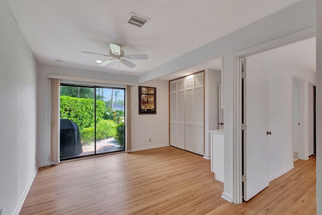 empty room with light wood-type flooring and ceiling fan