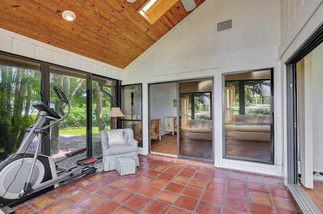 unfurnished sunroom featuring wood ceiling and vaulted ceiling with skylight