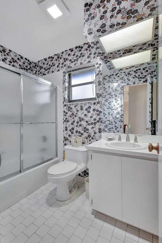 full bathroom with vanity, toilet, tile patterned floors, and enclosed tub / shower combo