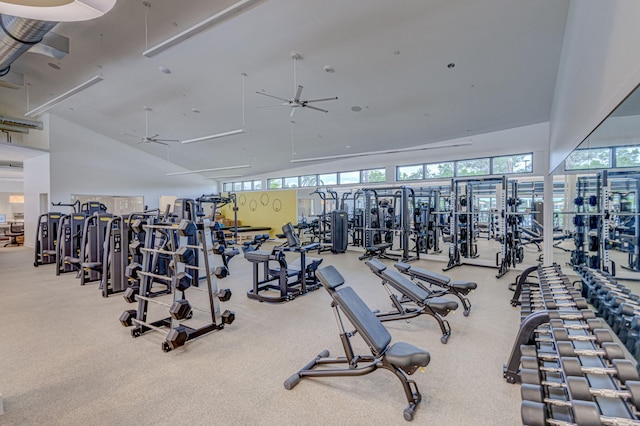 exercise room with light colored carpet, high vaulted ceiling, and ceiling fan