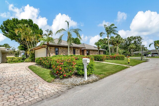 single story home with a garage and a front yard