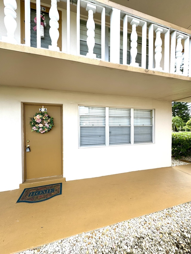 entrance to property featuring a balcony