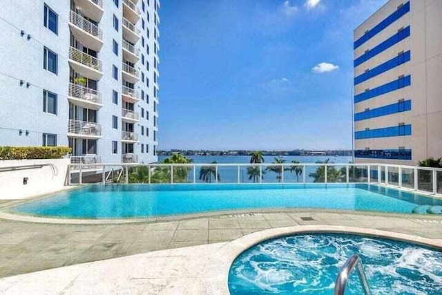 view of pool featuring a water view