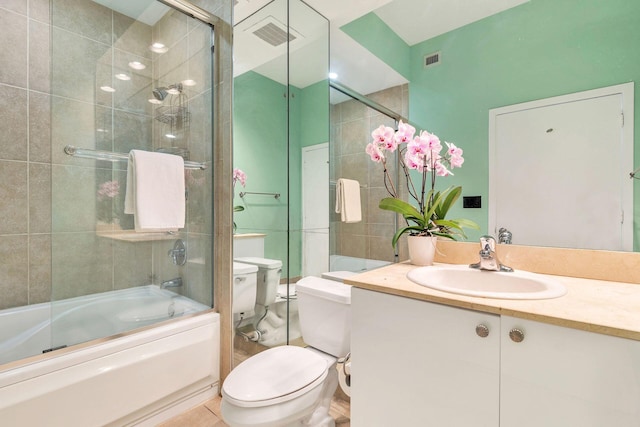 full bathroom with tile patterned floors, toilet, combined bath / shower with glass door, and vanity