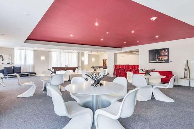 dining room featuring carpet, a tray ceiling, and pool table