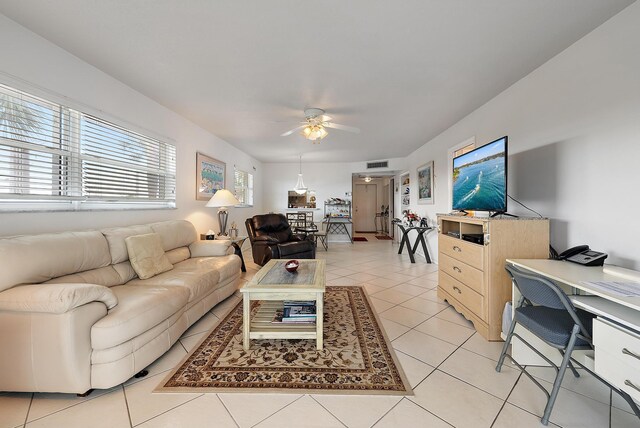 dining room featuring ceiling fan, light tile patterned floors, and a textured ceiling