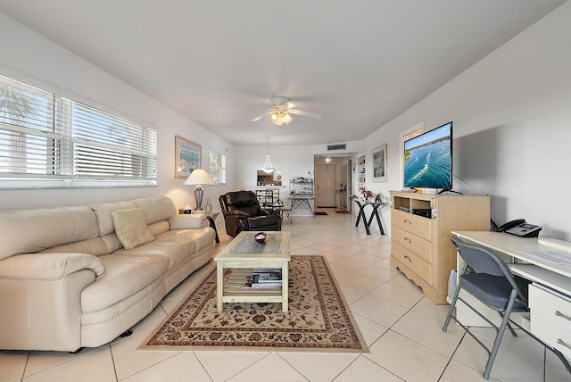 living area with ceiling fan, light tile patterned flooring, and visible vents