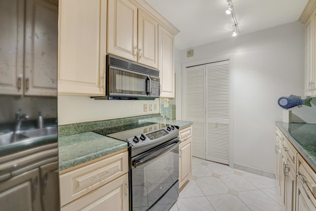 kitchen with sink, light tile patterned floors, rail lighting, and black appliances