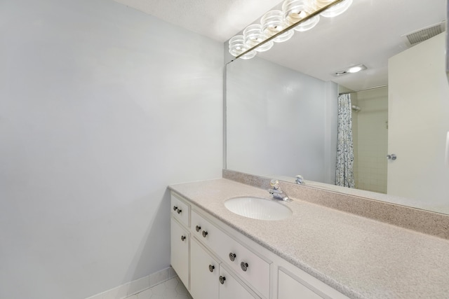 bathroom with vanity, a shower with curtain, and tile patterned floors