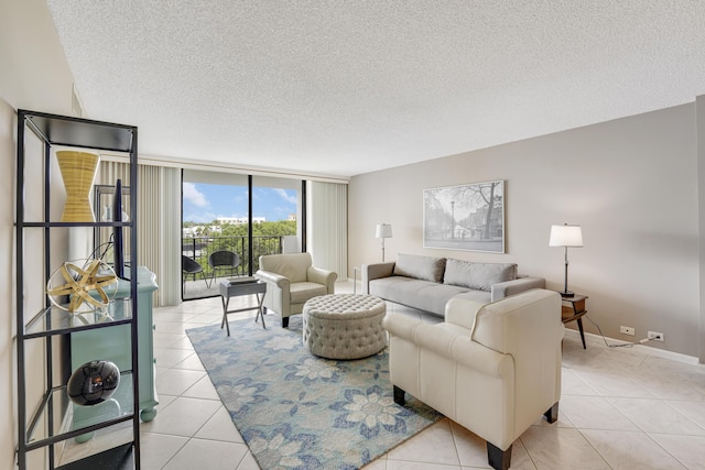 living room featuring a textured ceiling, light tile patterned flooring, and floor to ceiling windows