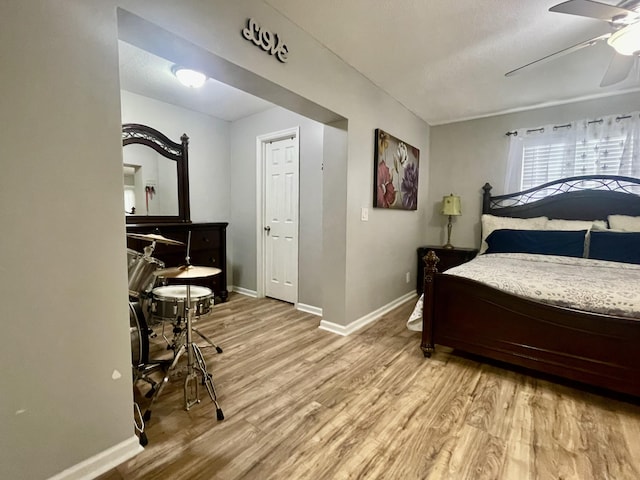 bedroom with ceiling fan and light hardwood / wood-style floors