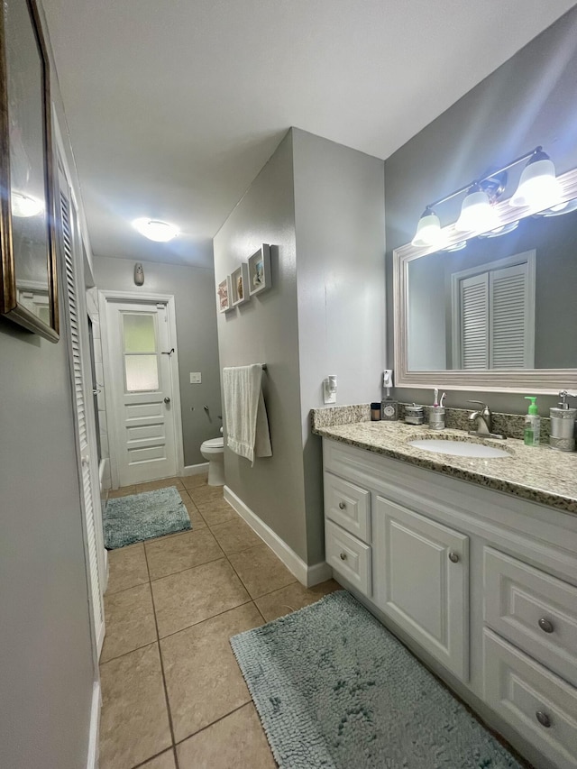 bathroom with tile patterned floors, vanity, and toilet