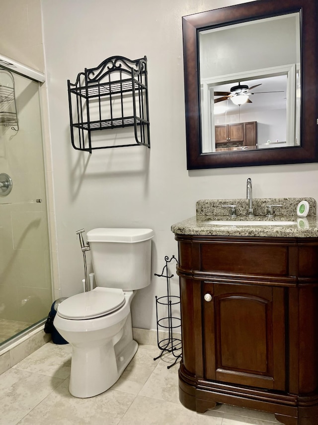 bathroom featuring vanity, ceiling fan, tile patterned flooring, toilet, and a shower with shower door