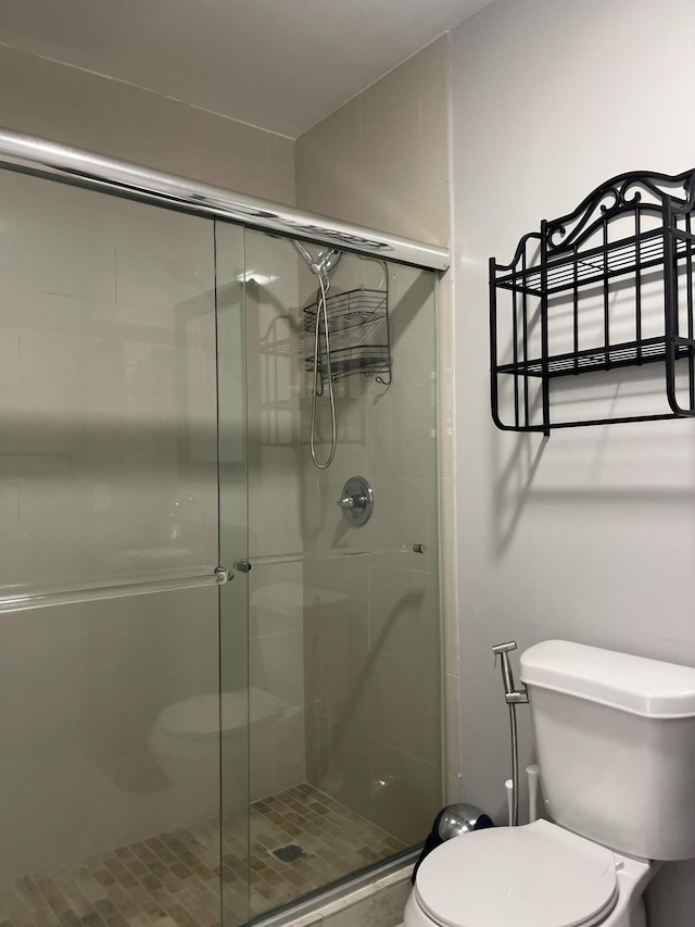 bathroom with an enclosed shower and toilet