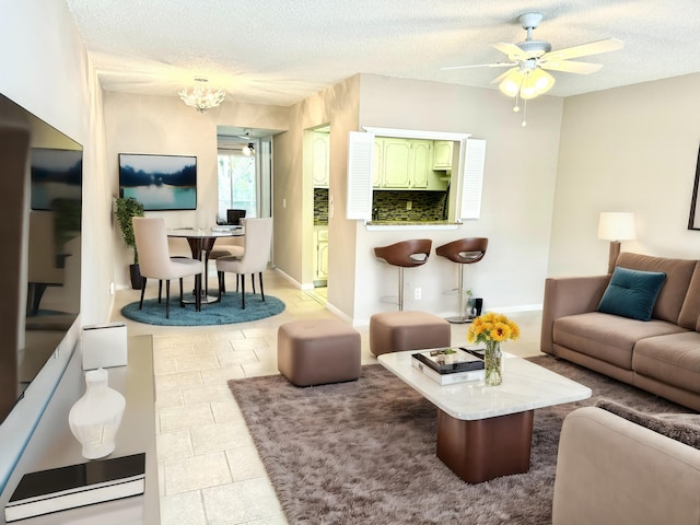 tiled living room with ceiling fan and a textured ceiling