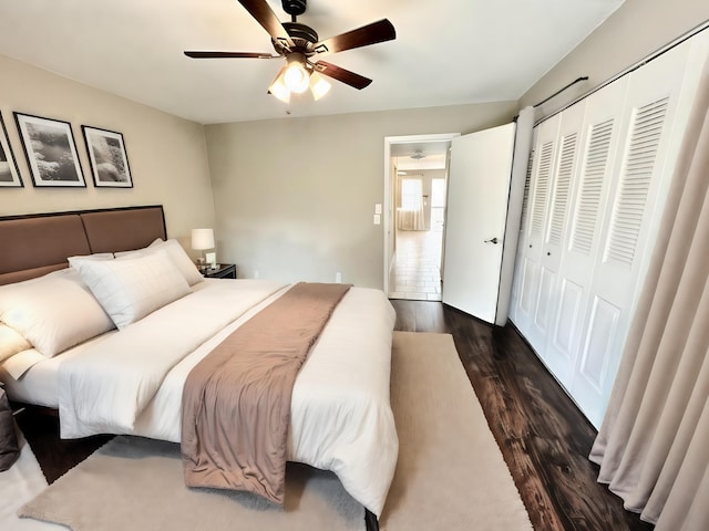 bedroom with a closet, ceiling fan, and dark hardwood / wood-style floors