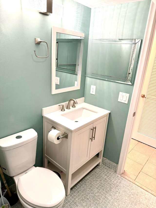 bathroom with vanity, toilet, and tile patterned flooring