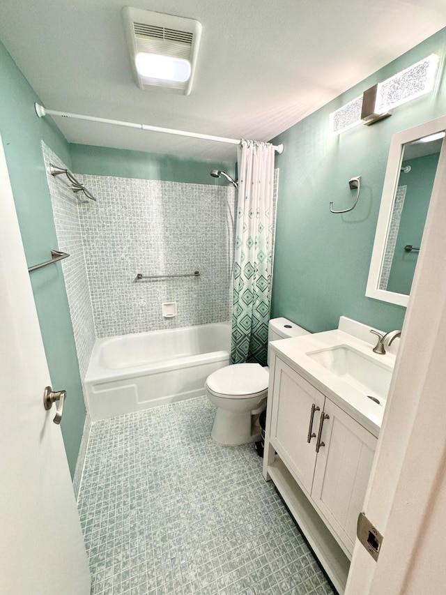 full bathroom with vanity, shower / bath combo with shower curtain, toilet, and tile patterned floors