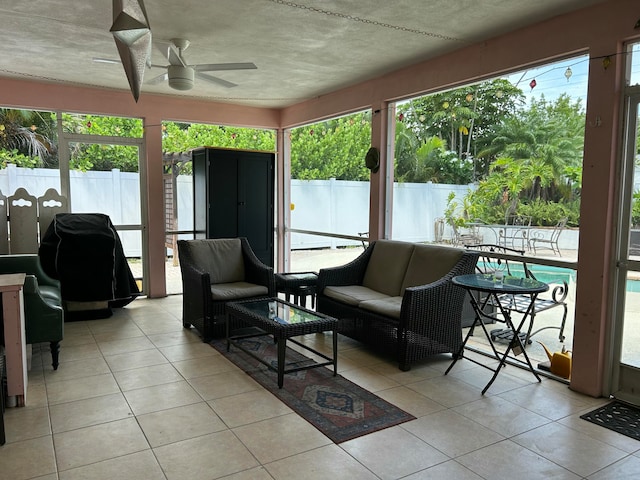 sunroom / solarium featuring ceiling fan and a healthy amount of sunlight