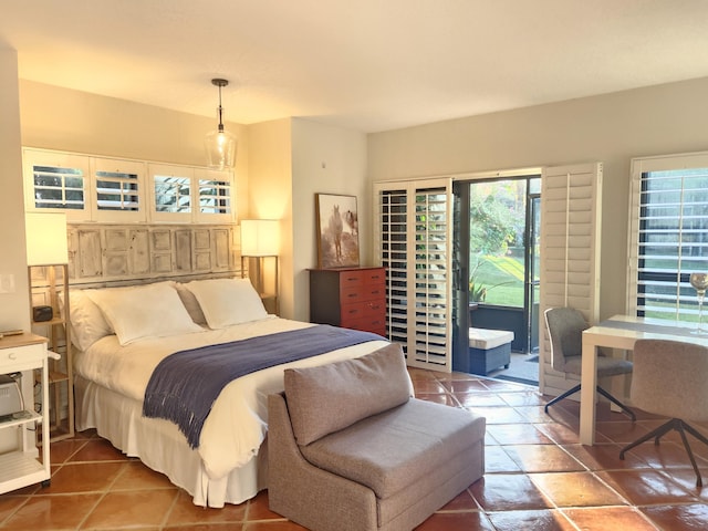 bedroom featuring access to exterior and tile patterned floors