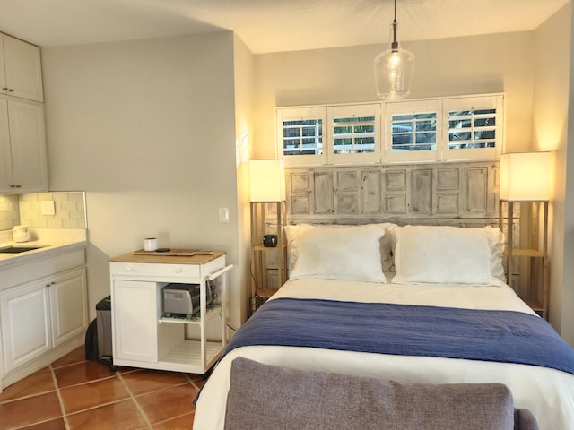 bedroom with sink and dark tile patterned flooring