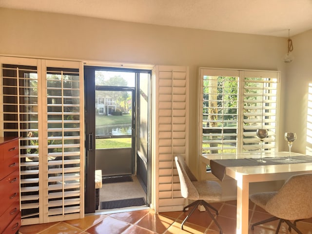 entryway featuring tile patterned flooring and a water view