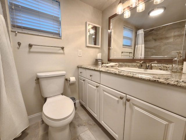 bathroom featuring curtained shower, vanity, and toilet