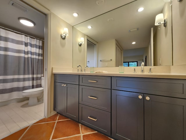 bathroom featuring tile patterned floors, vanity, and toilet