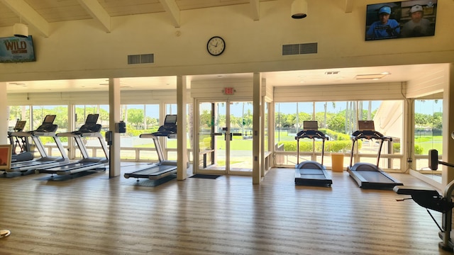 11863 Wimbledon Cir Unit 416, Wellington, FL 33414 - workout area with healthy amount of natural light, wood finished floors, and beam ceiling