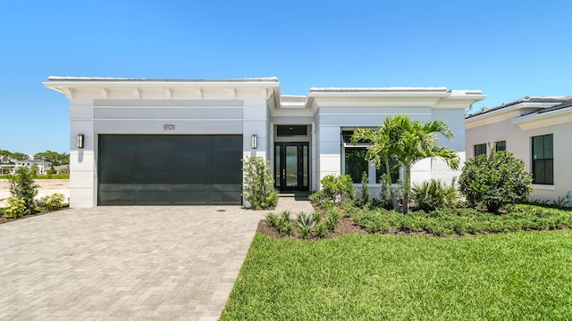 view of front facade featuring a front yard and a garage