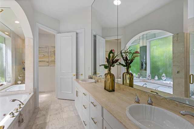 bathroom with vanity and independent shower and bath