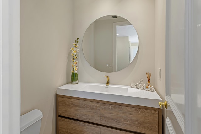 bathroom featuring vanity and toilet