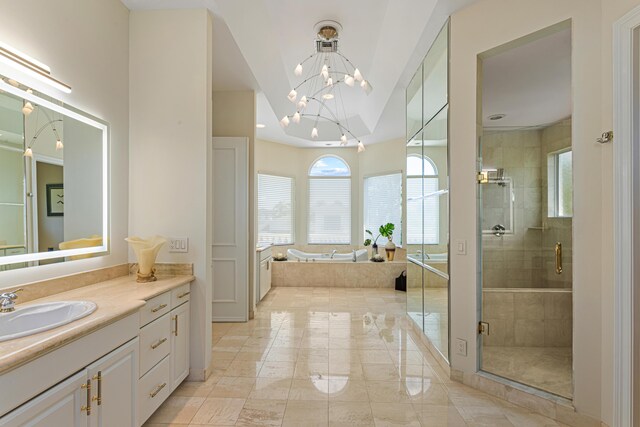 bathroom with vanity, separate shower and tub, vaulted ceiling, and an inviting chandelier