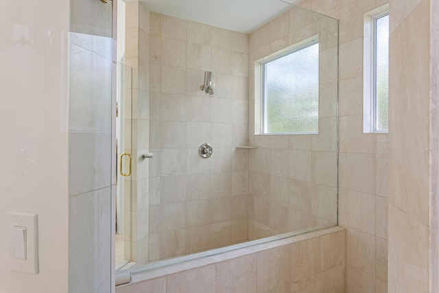 bathroom with a shower with door