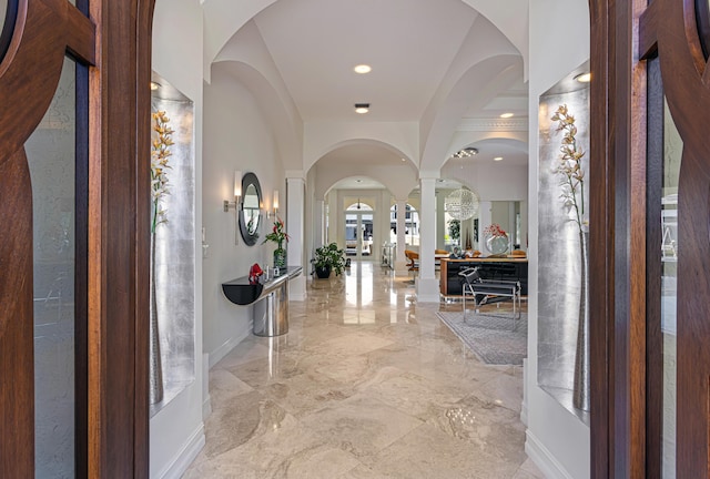 corridor with ornate columns and french doors