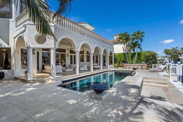 view of pool with an in ground hot tub, an outdoor living space, and a patio