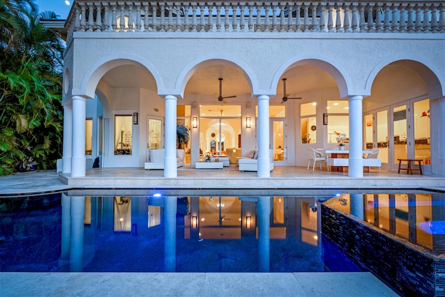 view of pool with ceiling fan and a patio