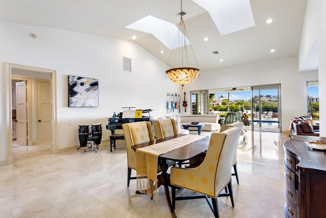 dining area featuring a skylight, high vaulted ceiling, and ceiling fan