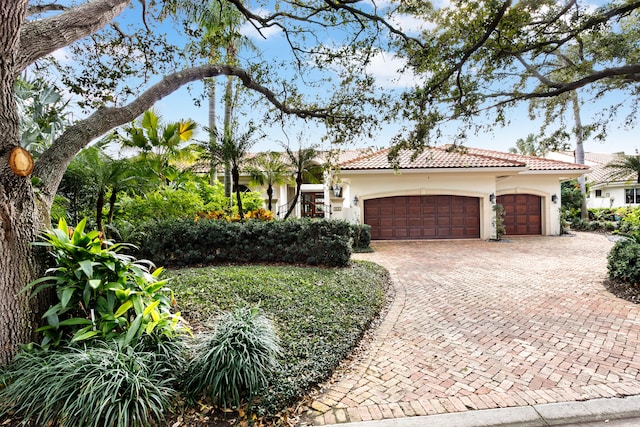 mediterranean / spanish-style home featuring a garage