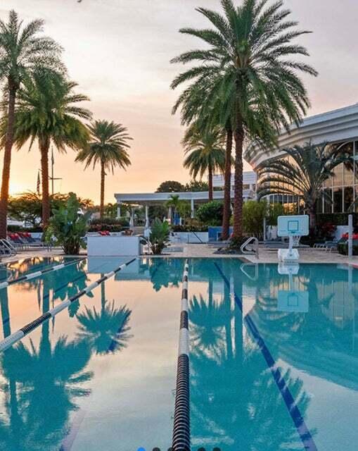 pool at dusk with a patio area