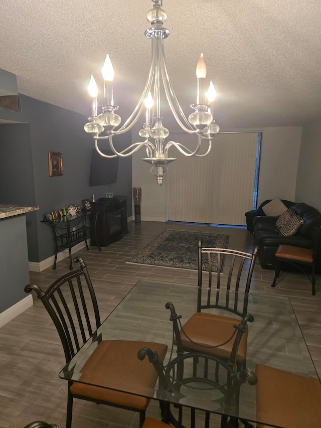 dining room featuring a textured ceiling and a chandelier