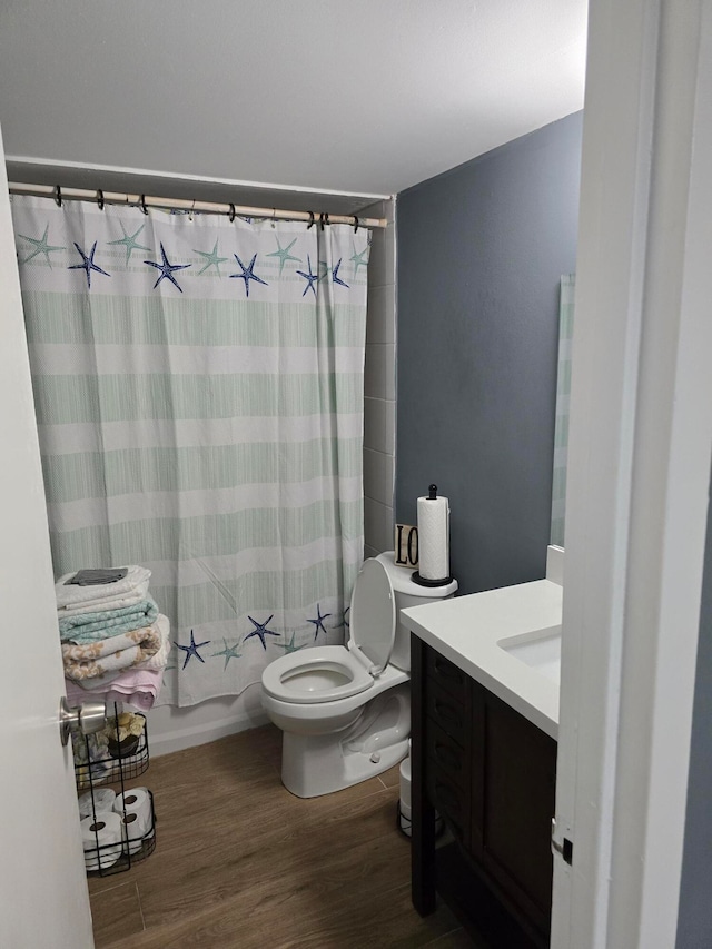 full bathroom featuring shower / bath combination with curtain, vanity, wood-type flooring, and toilet