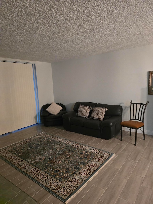 living room with hardwood / wood-style flooring and a textured ceiling