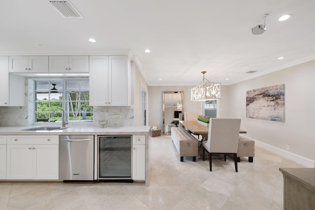 kitchen featuring dishwasher, white cabinets, sink, decorative backsplash, and beverage cooler