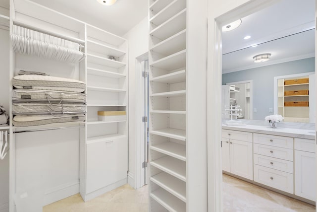 walk in closet featuring light tile patterned flooring