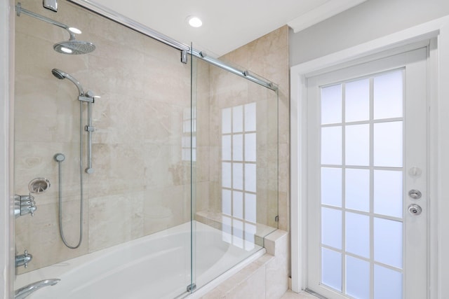 bathroom with bath / shower combo with glass door